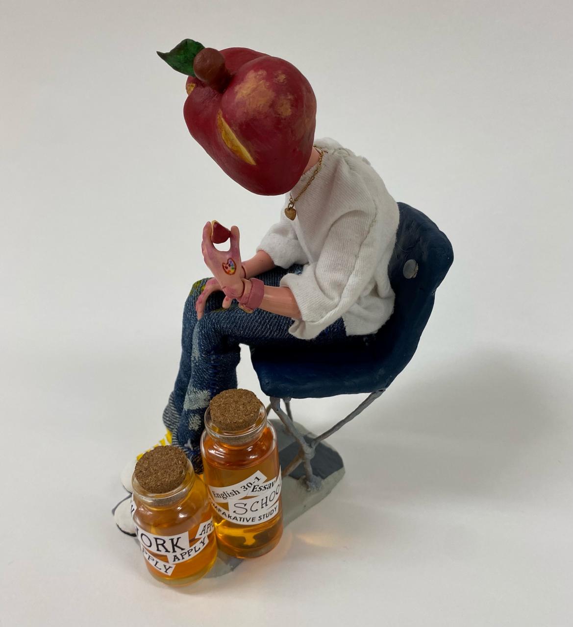 Sculpture of figure with apple for head