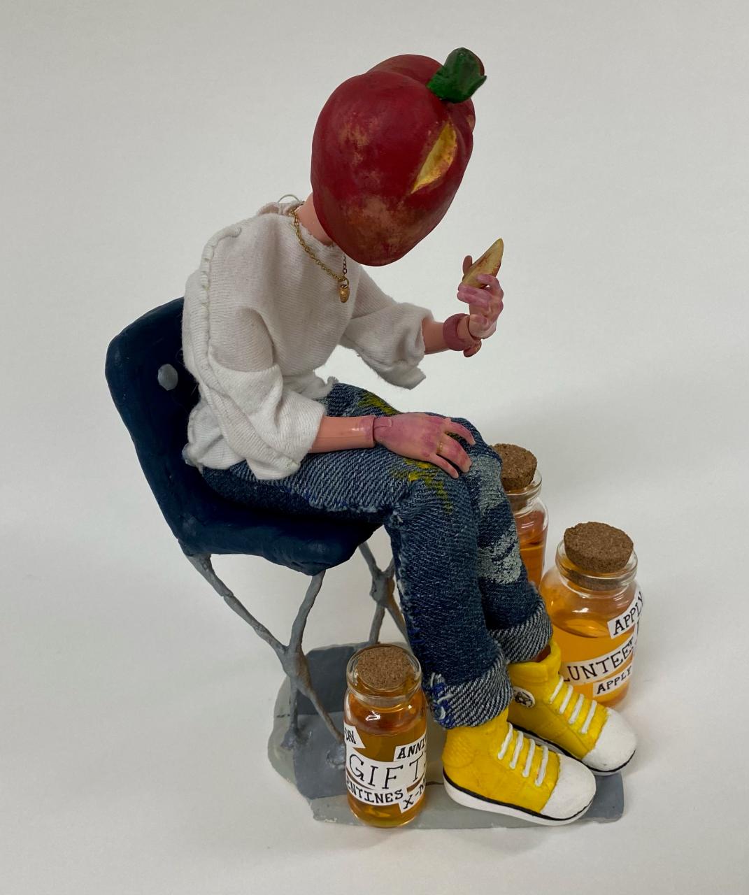 Sculpture of figure with apple for head