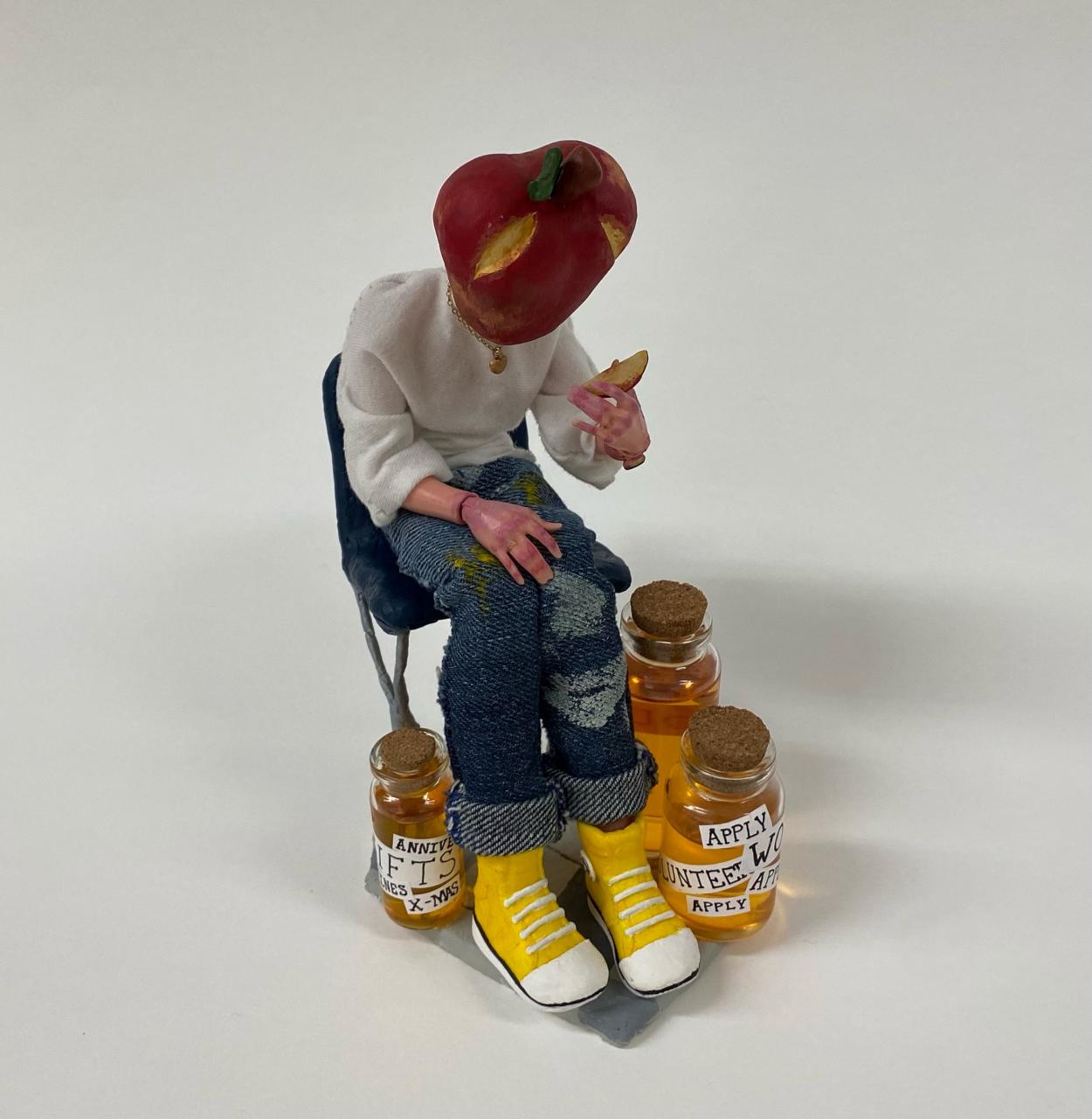 Sculpture of figure with apple for head