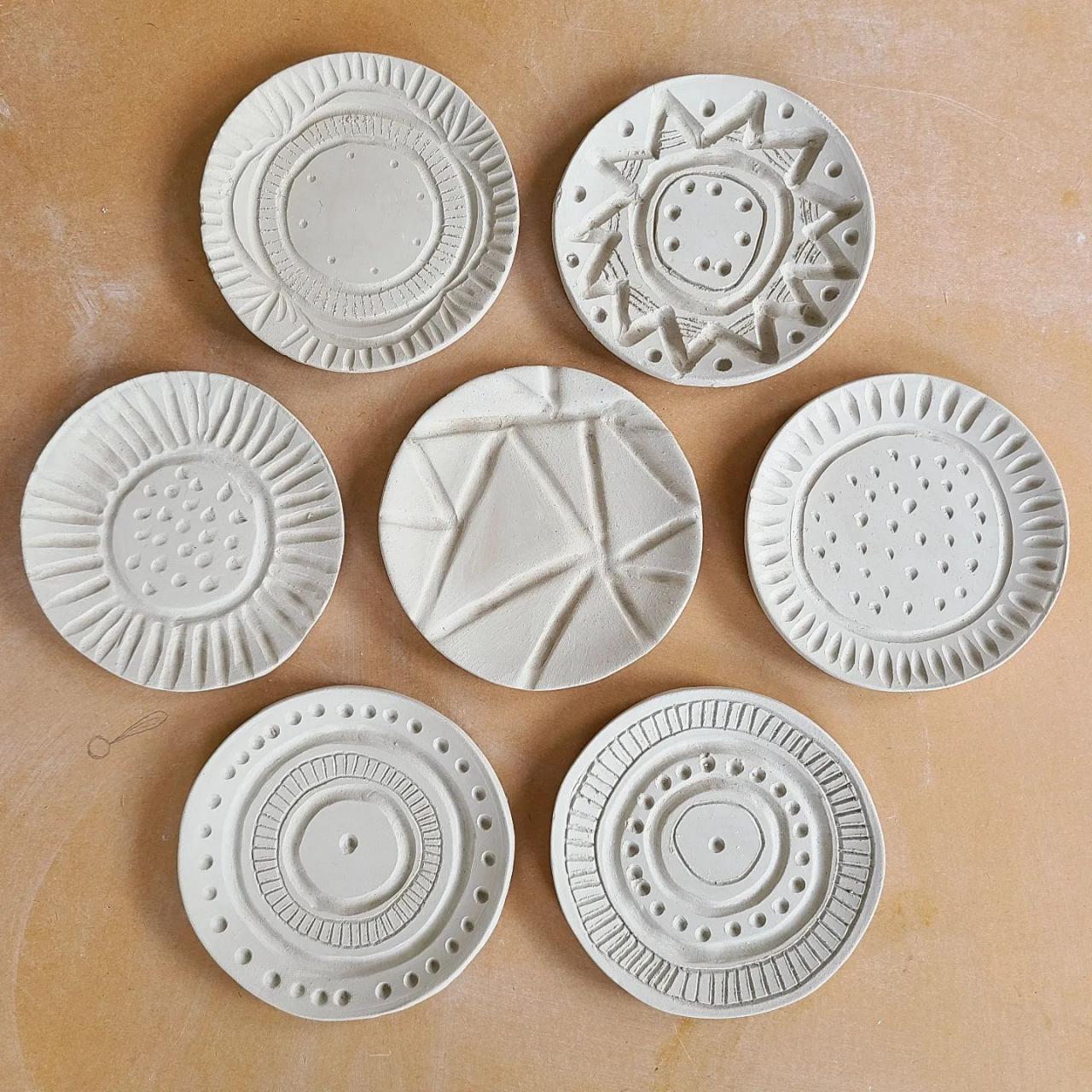 group of ceramic plates with various line art designs