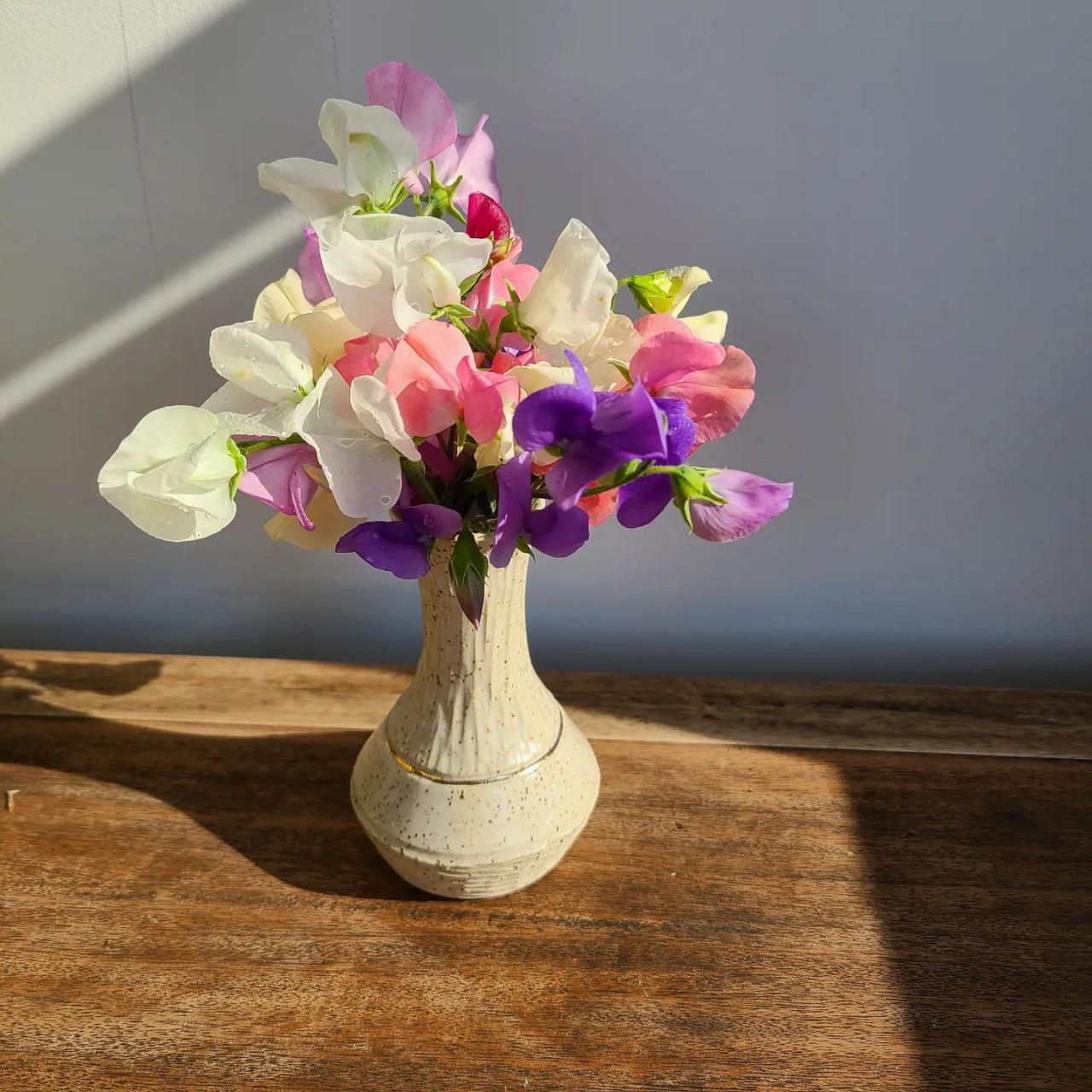 ceramic vase with pink, white, and purple flowers