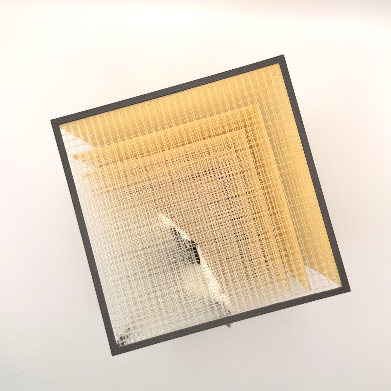 “Echoes of Transition” by Anahita Mosayebi, featuring a translucent grid structure framed in black.