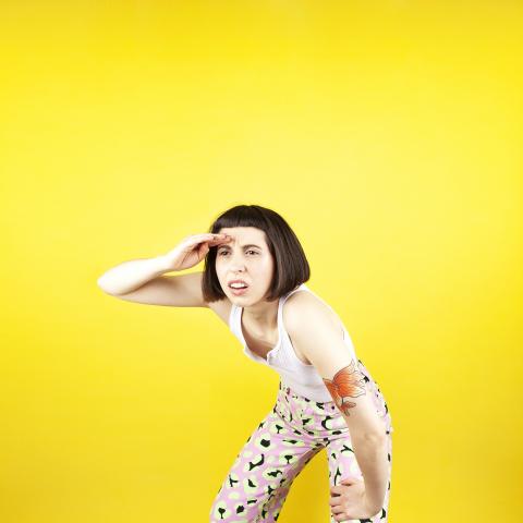 photo of instructor, Haley Eyre, with yellow background
