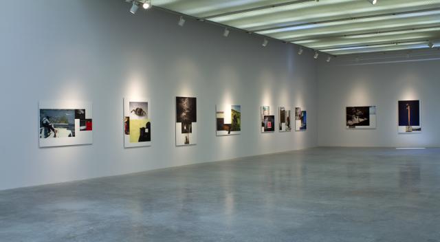 Gallery view from first entrance. There are nine of the montage prints visible hanging on the gallery walls. 