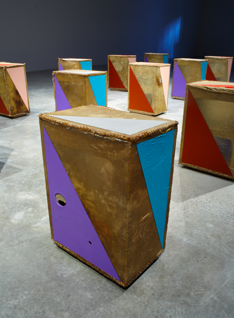 Close up of one of the objects. Purple, blue and white details. The objects can be seen in the back. 