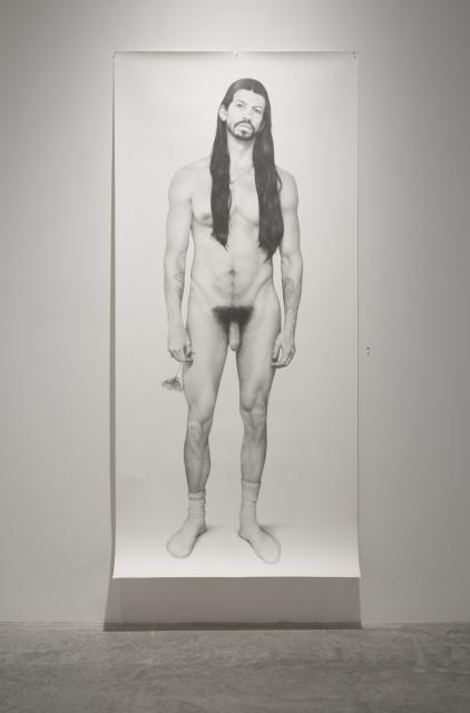 Detail of Duality 4: Adam & Eve (Lacey) (2010). A life size graphite drawing of the artist. They are holding a flower in their left hand. 