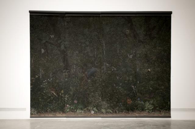 Detail of Eunuch Tapestry 3 (2013). The large scale pastel drawing features a dark flora scene with fauna peaking out from the leaves. In the middle we can see a person with their back turned.  