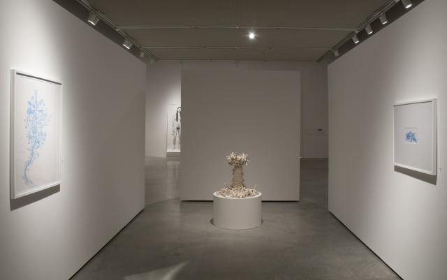 View of center of gallery. Two of the blue drawings are visible as well as the ceramic fountain.