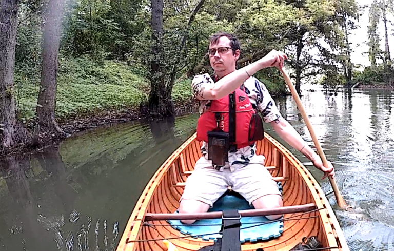 Photo of instructor, Shawn Chamberlain, rowing a canoe. 
