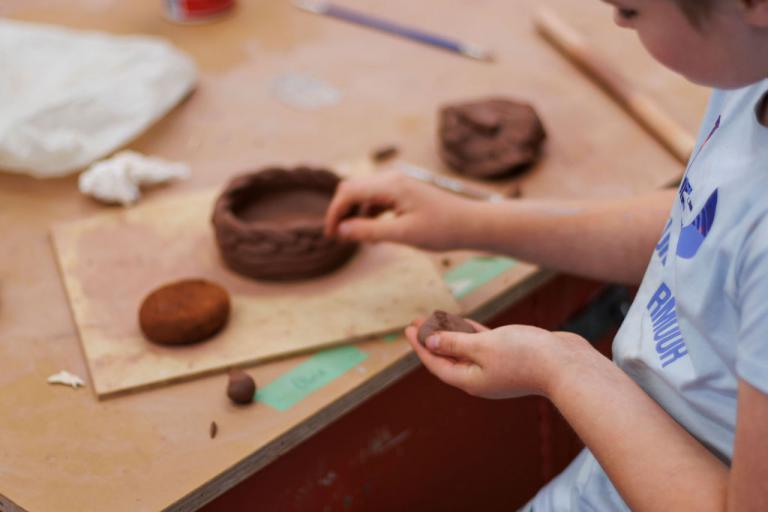 teen student making a ceramic sculpture