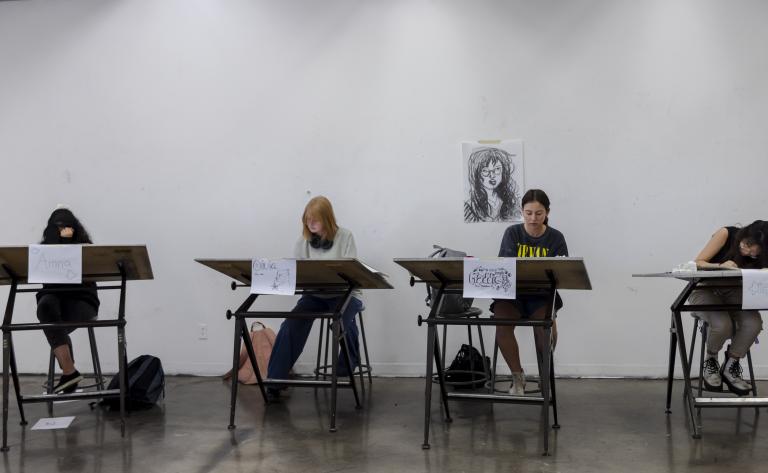 Teen drawing students working at their desks in a studio