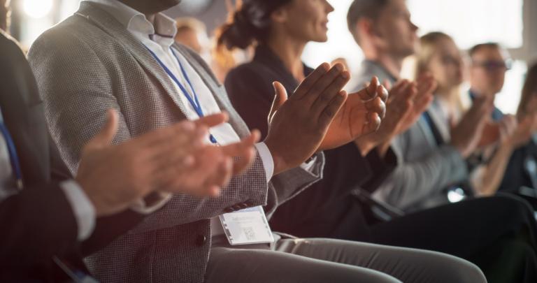 people at an event clapping